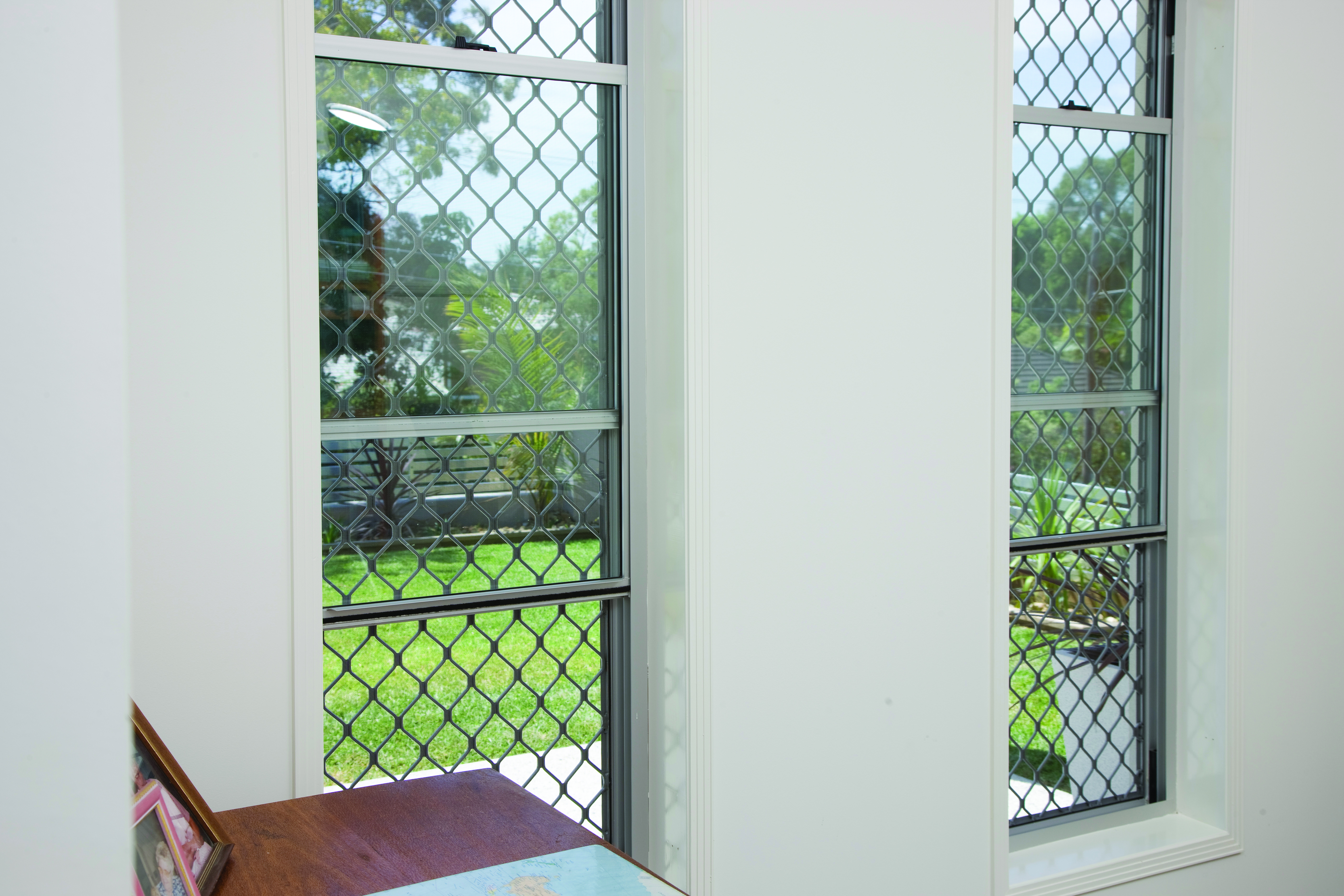 Prowler Proof Welded Diamond fixed window security screen on double hung windows
